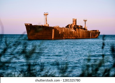 Old rusted and abandoned ship on the sea