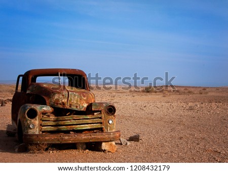Old rusted car desserted in the desert