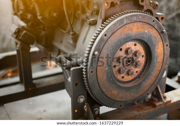 Old rusted car engine\
and clutch disc.