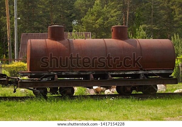 Old rusted car -
gasoline tank for narrow-gauge railways against the backdrop of
nature. Retro technology