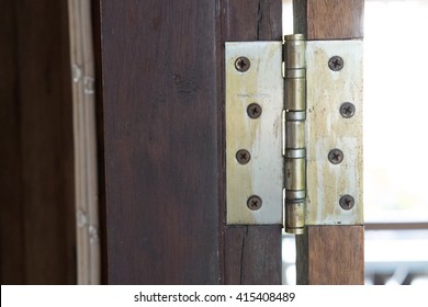 Old Rusted Hinge Holding Wooden Door