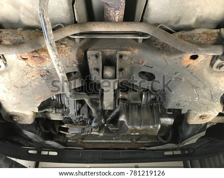 Old rusted oil leaking car with some broken parts on service for control and preparation for repairs and paid by insurance policy