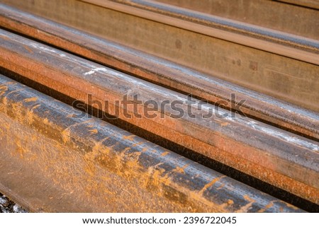Old rusted railroad rails on the gravel ground, close up upper view photo