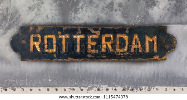 Old rusted steel ship plate with an imprint of\
the Dutch city of Rotterdam