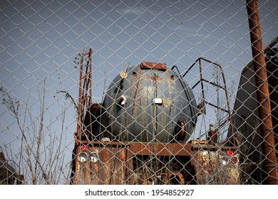 Old Rusted Tanker Truck Behind Fence