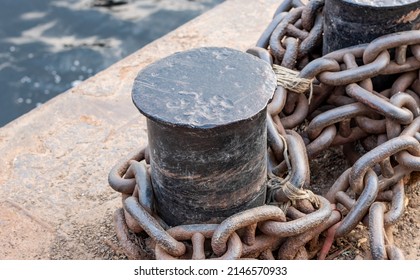 Old Rustic Anchor Pillar On The River Close Up Shot