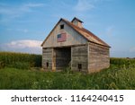 Old rustic barn in the Midwest with painted American flag.  LaSalle, Illinois, USA