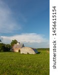 Old rustic barn in the Midwest as the sun begins to set.  LaSalle County, Illinois, USA