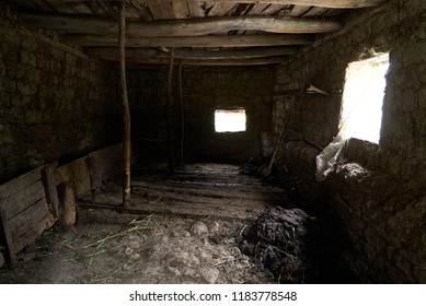 Old rustic clay cowshed interior with window and manure for fertilizer inside