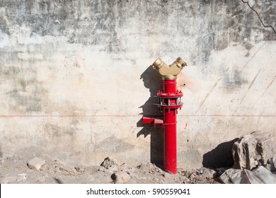 Old rustic grunge wall with fire hydrant.