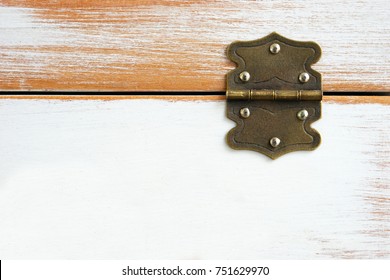 Old rustic hinge on box with white scratched paint / Hinge on grunge texture background  