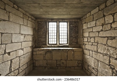Old rustic looking midieval window cell with bricks