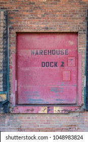 Old Rustic Red Warehouse Dock Door On Brick Wall