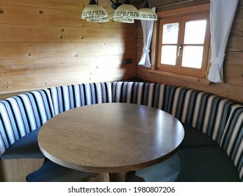 An Old Rustic Sitting Area With A Round Table In A Tyrolean Farmhouse.