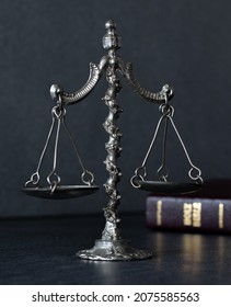 Old Rustic Vintage Ancient Balance Weighing Scale With Closed Holy Bible Book On Dark Background. Christian Biblical Concept Of Law And Justice. God Jesus Christ Is Righteous Judge. A Closeup.