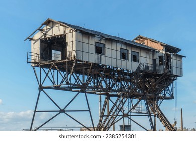 An old rusting abandoned coal loader stands on the iron structure