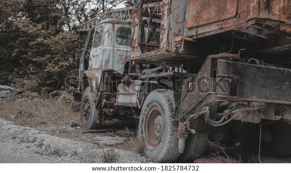 Old, rusty, abandoned truck crane in the woods.\
Old, rusty interior elements, controls and indicators. Interior\
close-up.