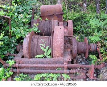 Old Rusty Abandoned Wire Winch In The Forest