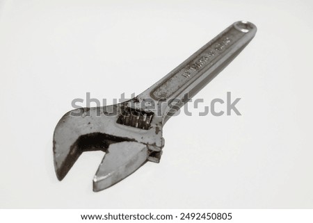 Old rusty adjustable wrench isolated on white background