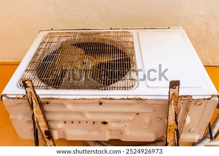 Old rusty air conditioning unit on the wall in Playa del Carmen Quintana Roo Mexico.