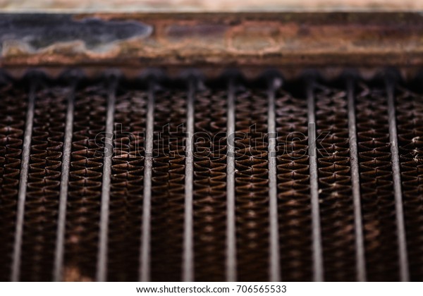Old, rusty automotive cooler. Rusty, red lattice\
texture. Grid.