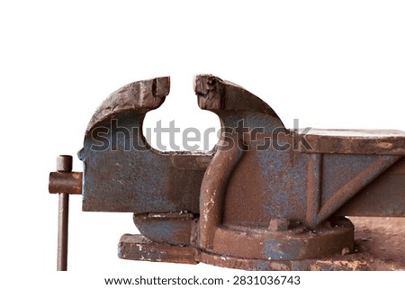Old rusty bench vise with blue paint isolated on white background.