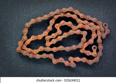 Old Rusty Bike Chain On Sandpaper Black Background