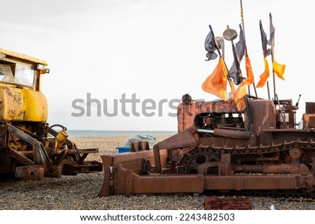 Old rusty bulldozer seen on a beach, used to tow fishing vessels to and from the water's edge.