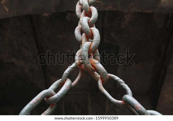 old rusty\
chain divided halfway into to\
chains