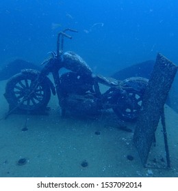 The Old Rusty Creepy Scary Haunted Ghost Motorcycle Wreck Under Deep Blue Sea In Scuba Divingn Trip Working As Artificial Coral Reef Mor Marine Life To Conservative Environment 
