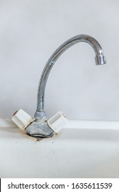 Old Rusty Dirty Faucet On The Washstand. There Is No Hot Or Cold Water In The Tap, And The Water Supply Is Being Repaired. The Concept Of Turning Off Water For Non-payment Of Utilities.