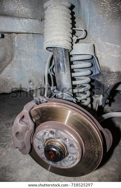 Old rusty disc brake of the car to be fixed and\
maintenance in the garage