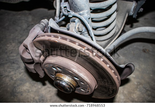 Old Rusty disc brake of the old car to be\
maintenance and  fixed in the\
garage
