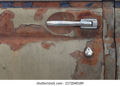 Old rusty door of a Soviet retro car. The fall of the car sales market in Russia. Lack of spare parts for car repairs. Car dump. The concept of decline and ruin