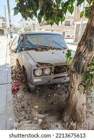 Old rusty and dusty car parked in the street.  - Shutterstock ID 2213675613