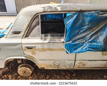 Old rusty and dusty car parked in the street.  - Shutterstock ID 2213675615