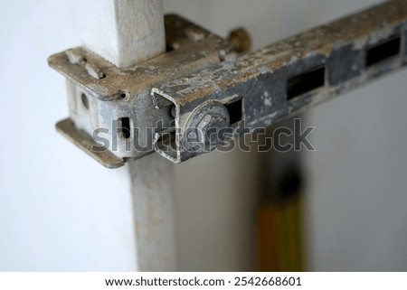 old rusty and faded construction element, slider, worn metal element for closing the gate structural, old-fashioned, surface damage, worn-out slider metal component, metal gate, deteriorating industry
