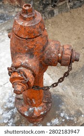 Old Rusty Fire Hydrant with Corroded Metal and Chain Close Up