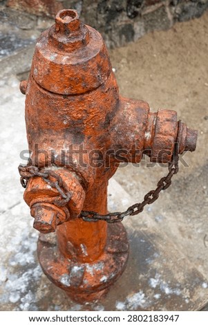 Old Rusty Fire Hydrant with Corroded Metal and Chain Close Up