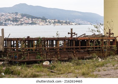 Old rusty floating pontoon of the mooring for boats on the shore