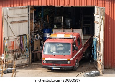 Old rusty garage service with car inside