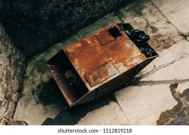 Old Rusty Garbage Container Full Of Trash In Plastic Bags, High Angle View