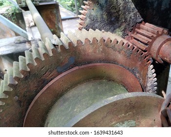 Old rusty gears from ancient dam on a huge river