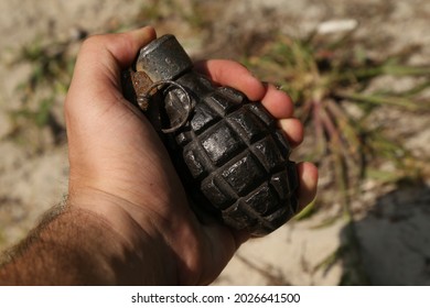 Old Rusty Grenade In Hand