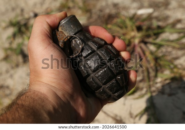 Old rusty grenade in\
hand