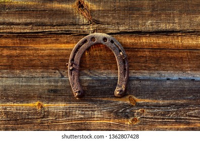 old rusty horseshoe on wood