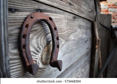 Old rusty horseshoe on a wooden background 