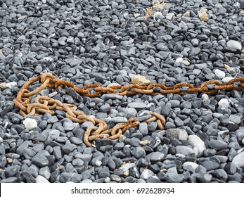 Old Rusty Industrial Chain On The Gravel, Refer To Business Concept Of Breaking Free From Problem.