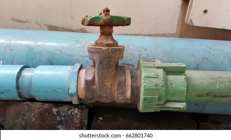 old rusty industrial tap water pipe and valve