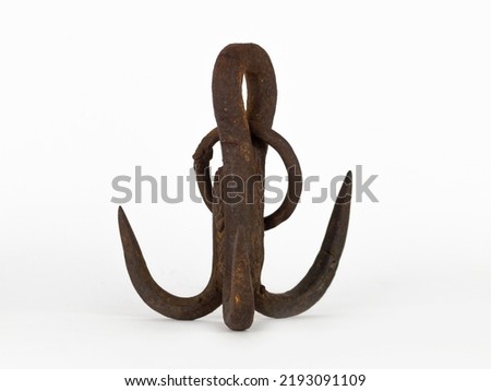 Old rusty iron anchor isolated on white background.